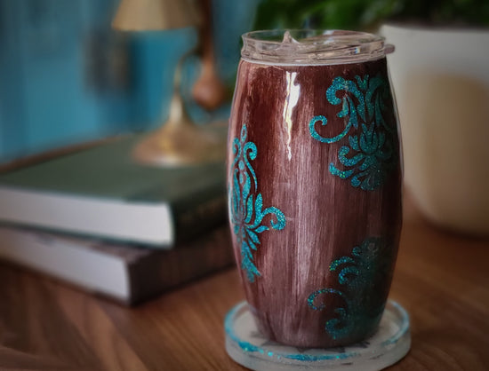 Woodgrain cup with teal filigree on side table